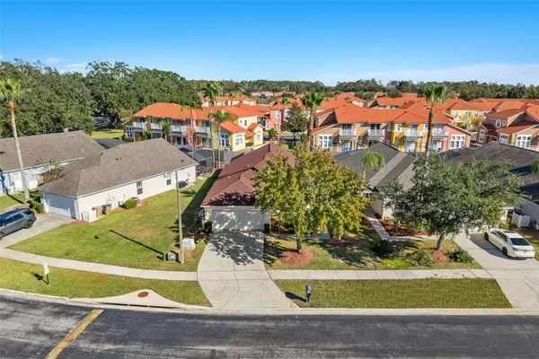 an aerial view of residential houses with outdoor space