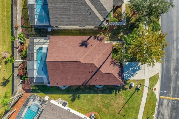 an aerial view of residential houses with outdoor space and swimming pool