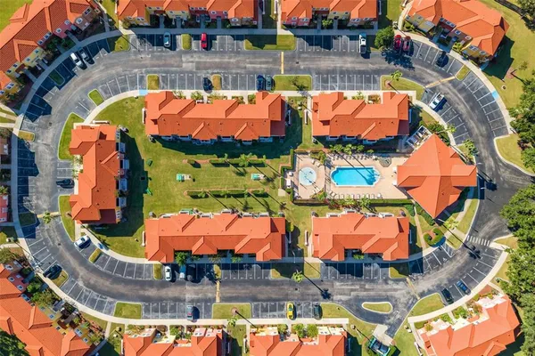 an aerial view of residential houses with outdoor space