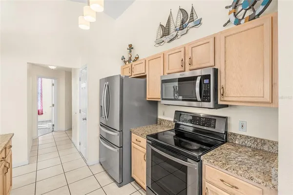 a kitchen with stainless steel appliances a stove a microwave and a refrigerator