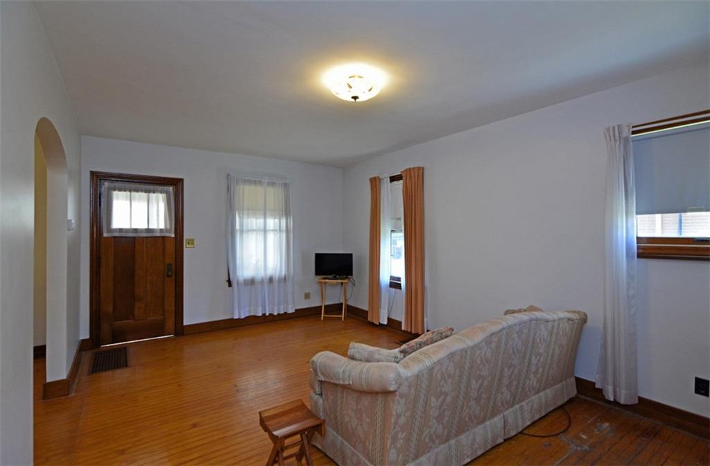 6902 Shannon Road Verona, PA 15147 - Photo 2 of 15 Classic oak hardwood flooring underscores the neutral-colored living room.