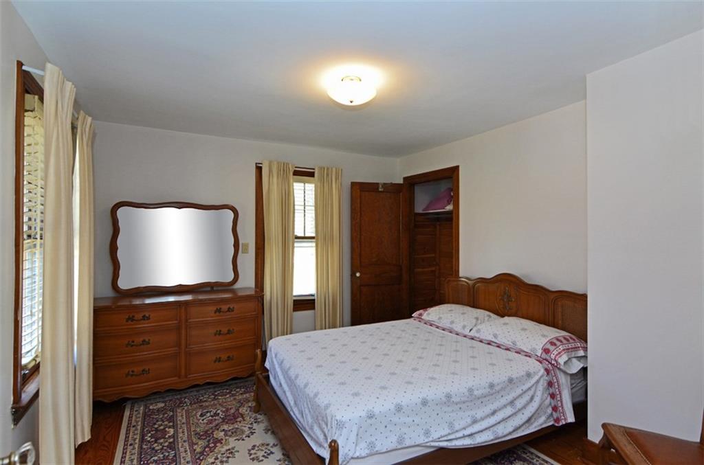 6902 Shannon Road Verona, PA 15147 - Photo 11 of 15 The third bedroom is situated across from the full bath, and includes hardwood flooring and a cedar closet.