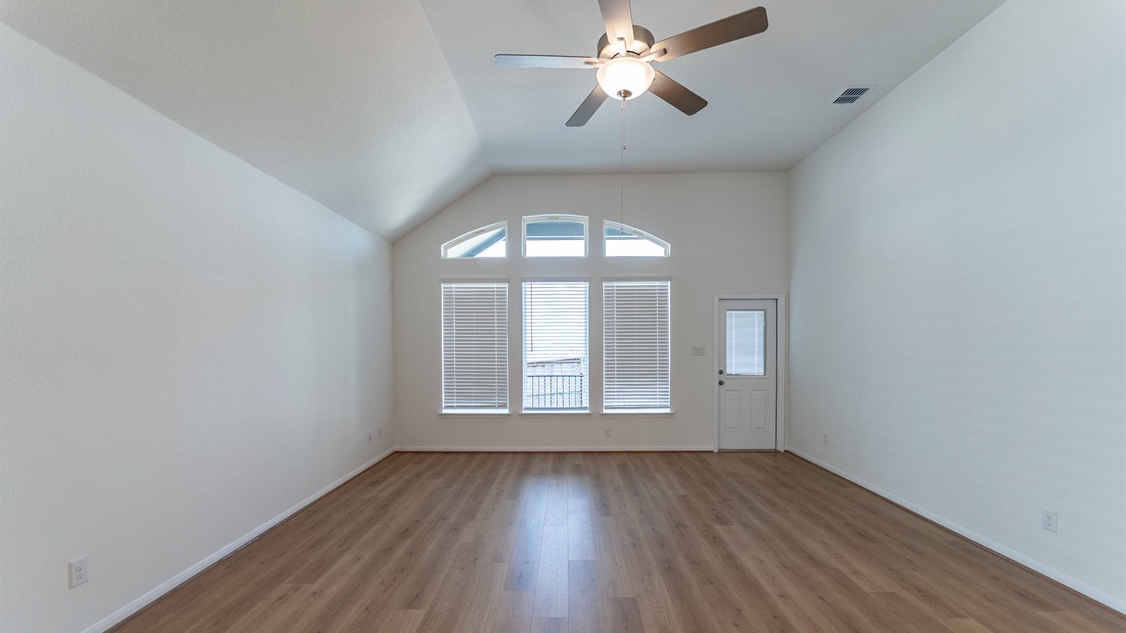 251 Grey Leaf Road Buda, TX 78610 - Photo 7 of 17 Spare room with wood finished floors, ceiling fan, and lofted ceiling