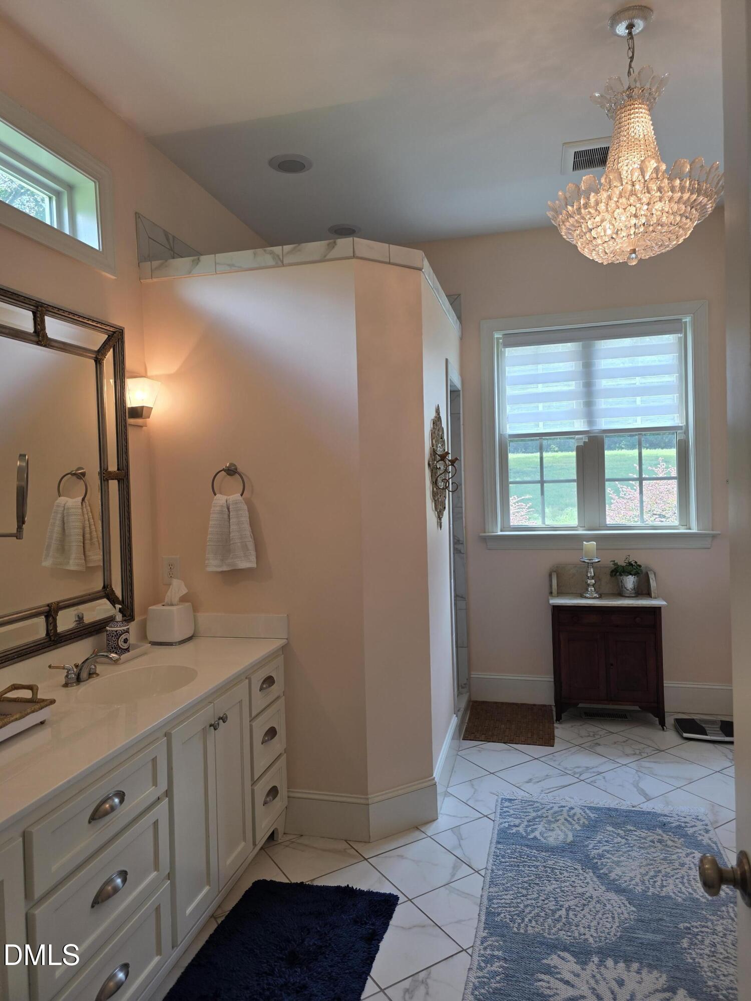 413 Johnson Town Road Zebulon, NC 27597 - Photo 16 of 42 a spacious bathroom with a double vanity sink and a mirror