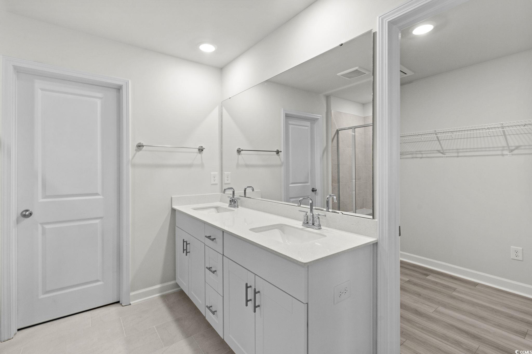2409 Copper Crk Loop Longs, SC 29568 - Photo 13 of 40 Full bath featuring double vanity, a shower stall, a walk in closet, and recessed lighting