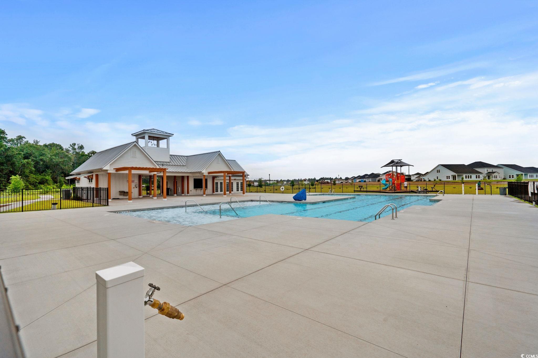 2409 Copper Crk Loop Longs, SC 29568 - Photo 27 of 40 Community pool with a patio