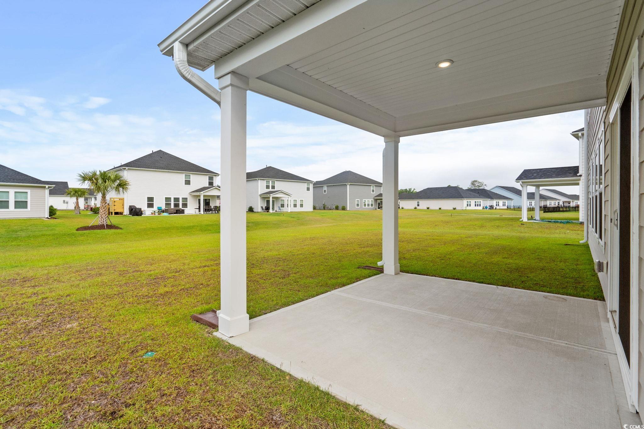2409 Copper Crk Loop Longs, SC 29568 - Photo 32 of 40 View of green lawn featuring a residential view and a patio