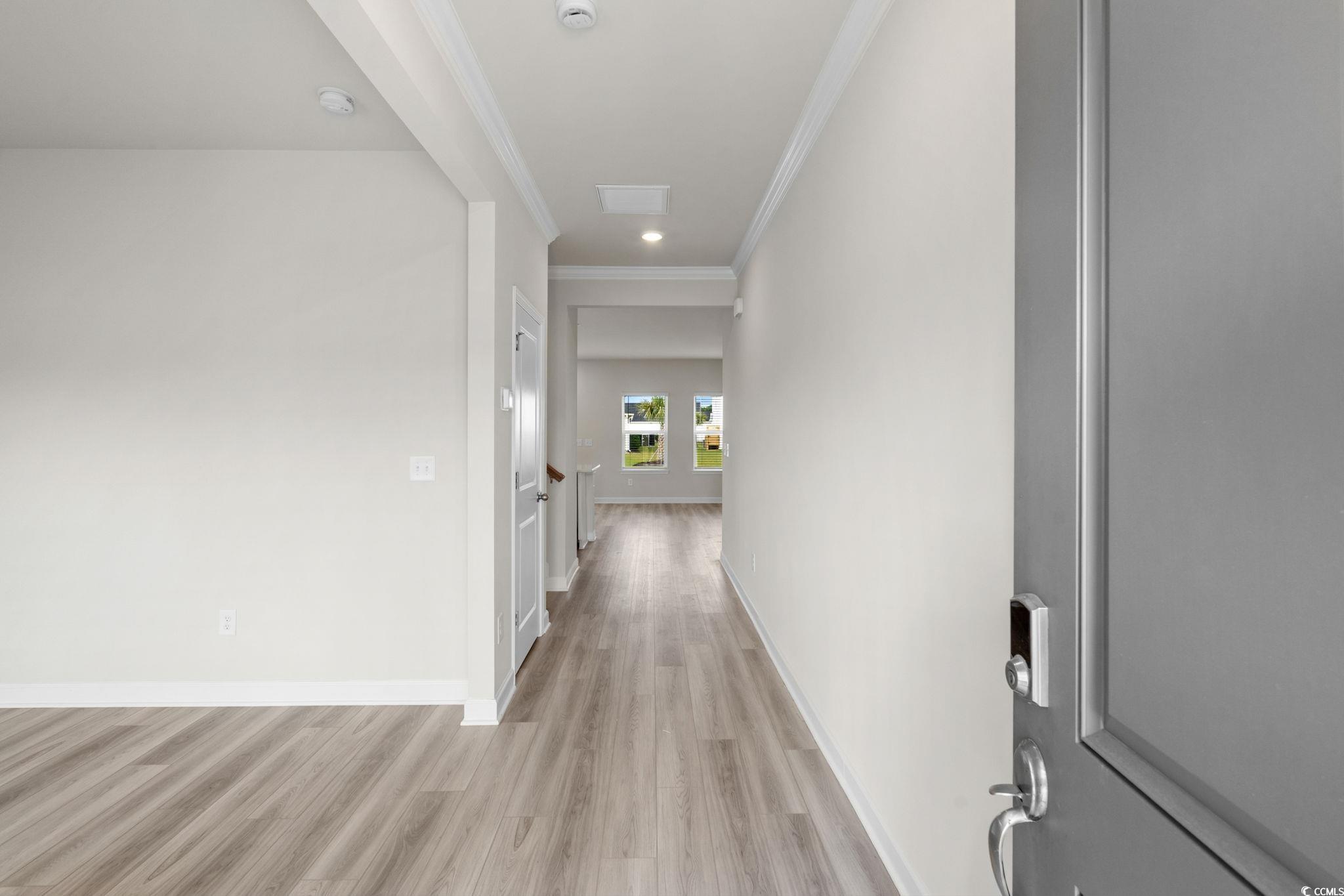 2409 Copper Crk Loop Longs, SC 29568 - Photo 5 of 40 Corridor featuring light wood finished floors, crown molding, and recessed lighting