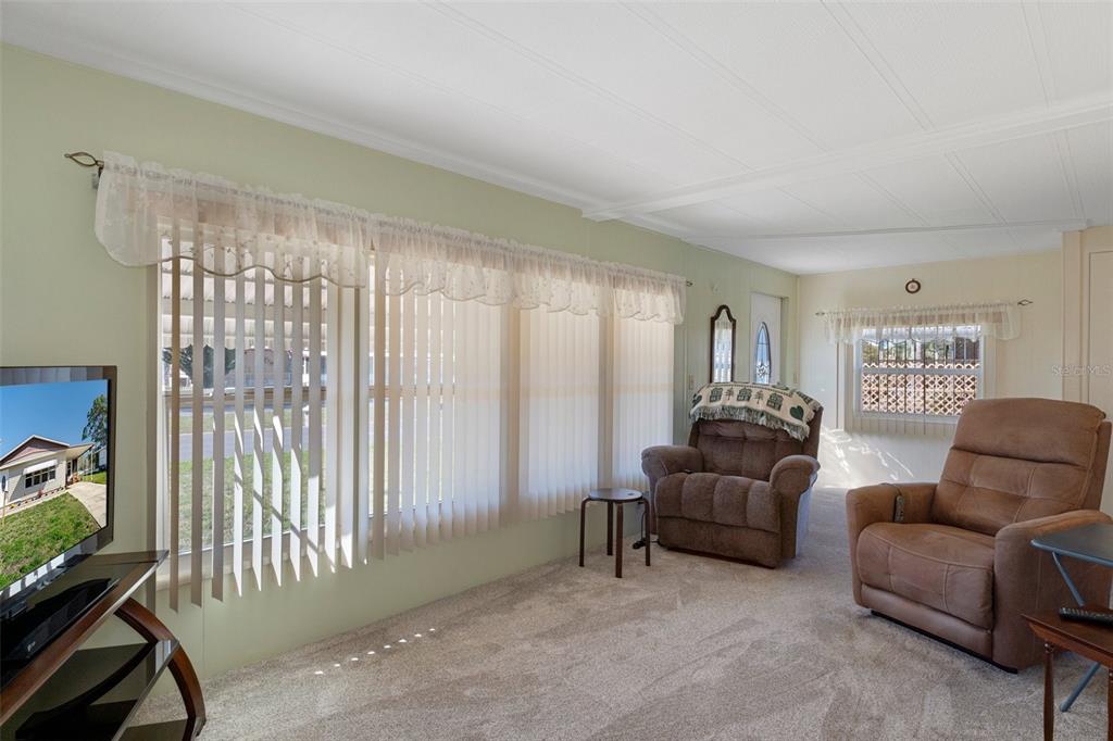 14751 Brookridge Boulevard Brooksville, FL 34613 - Photo 13 of 61 a living room with furniture and a window