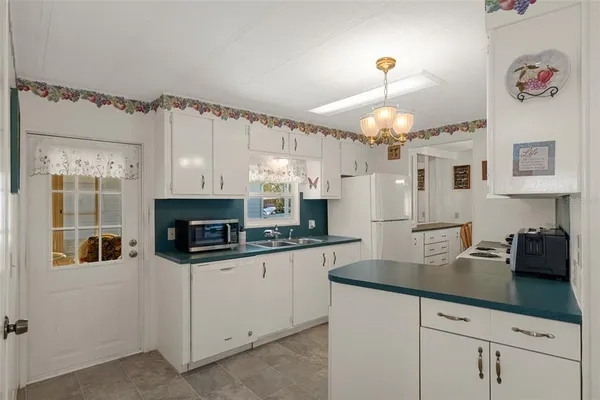 a kitchen with stainless steel appliances granite countertop a sink a stove and cabinets