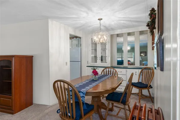 a view of a dining room with furniture and chandelier