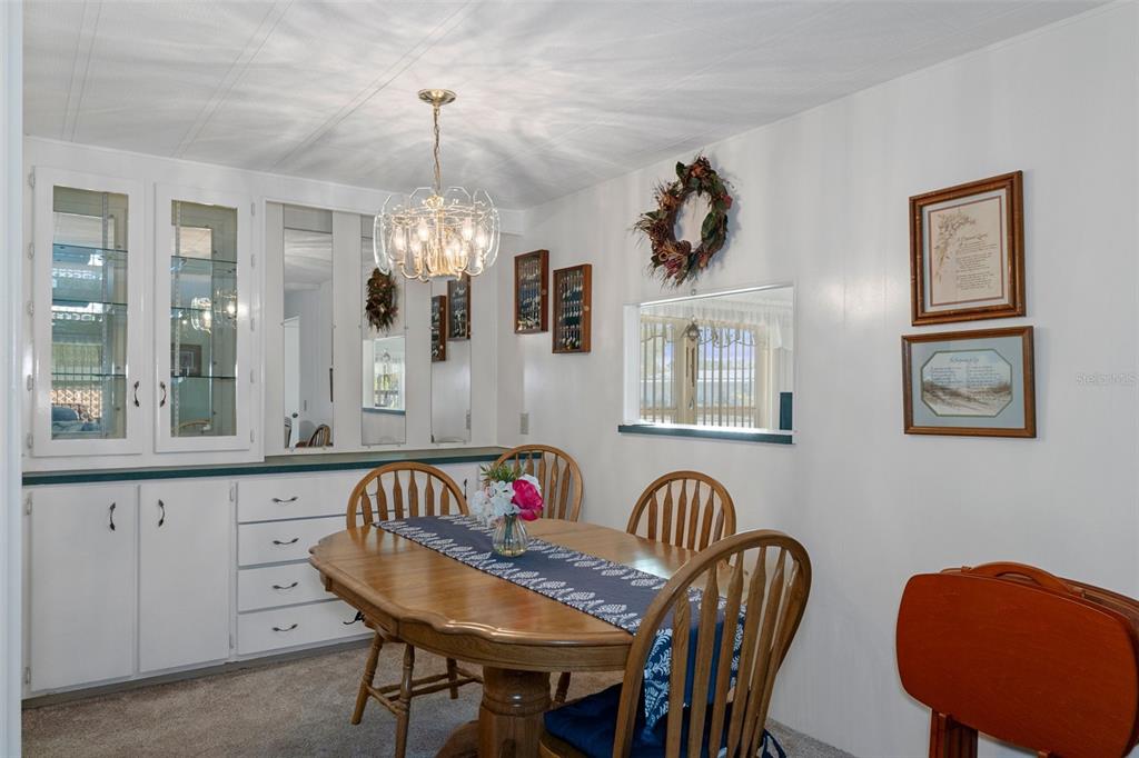 14751 Brookridge Boulevard Brooksville, FL 34613 - Photo 21 of 61 a view of a dining room with furniture and chandelier