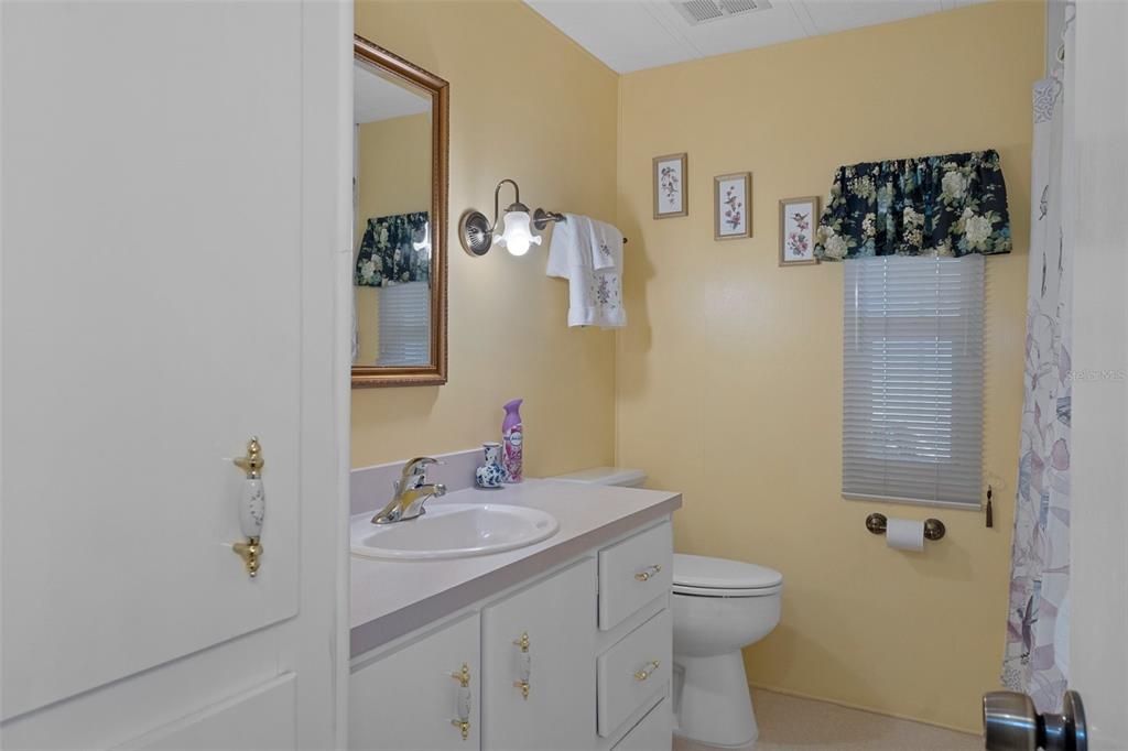 14751 Brookridge Boulevard Brooksville, FL 34613 - Photo 23 of 61 a bathroom with a toilet a sink and mirror