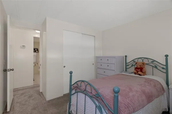 a living room with a floor to ceiling window next to a yard