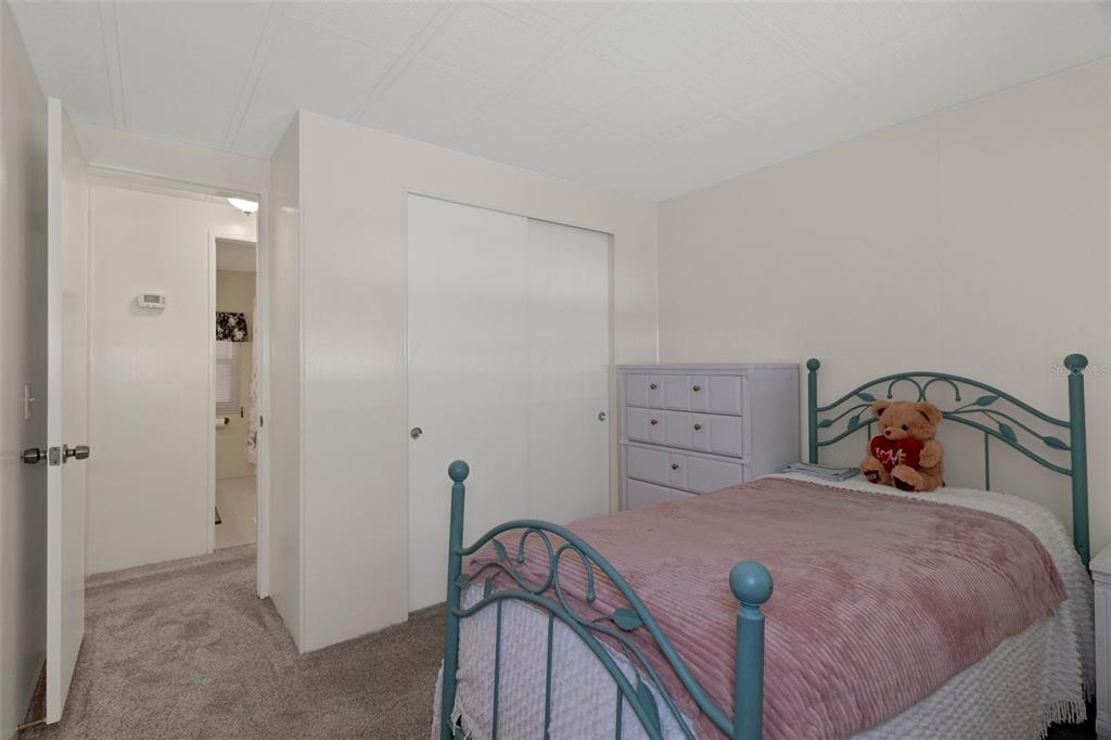 14751 Brookridge Boulevard Brooksville, FL 34613 - Photo 31 of 61 a bedroom with a bed and a table in it