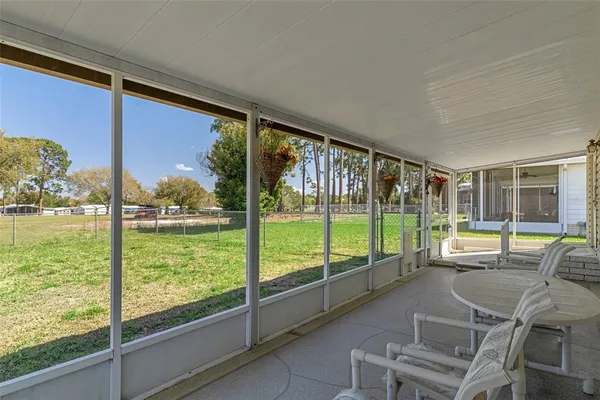 a view of a house with backyard sitting area and garden