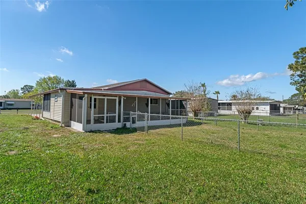 a view of a field with grass and trees