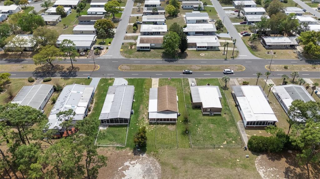 14751 Brookridge Boulevard Brooksville, FL 34613 - Photo 59 of 61 an aerial view of multiple houses with yard