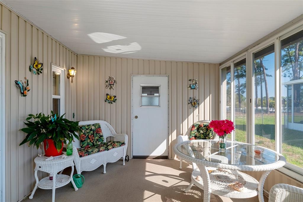 14751 Brookridge Boulevard Brooksville, FL 34613 - Photo 6 of 61 a living room with furniture and flowers