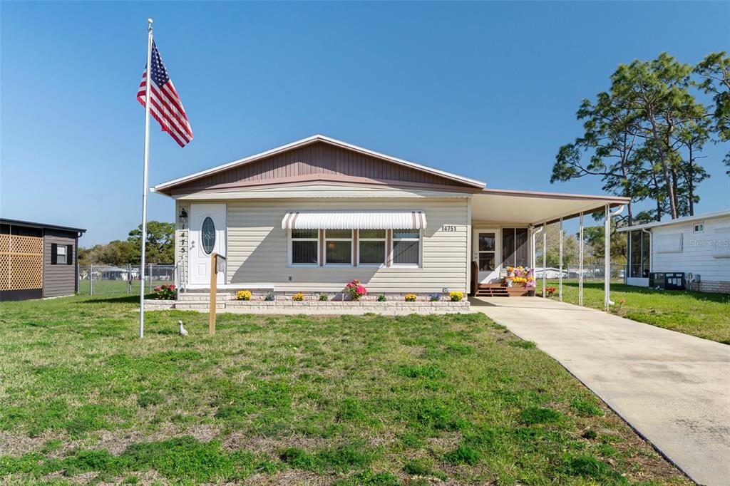 14751 Brookridge Boulevard Brooksville, FL 34613 - Photo 61 of 61 a front view of a house with a yard and porch
