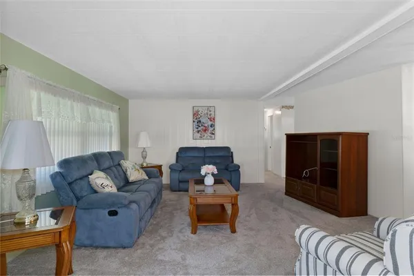 a living room with furniture and a glass door