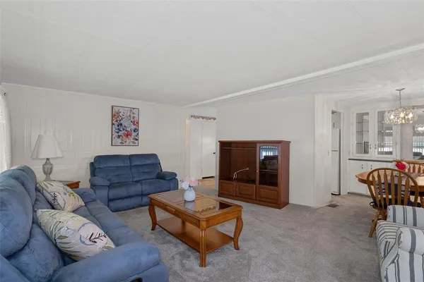 a living room with furniture a couch and a dresser