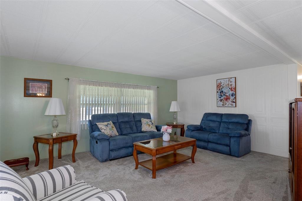 14751 Brookridge Boulevard Brooksville, FL 34613 - Photo 10 of 61 a living room with furniture a couch and a dresser