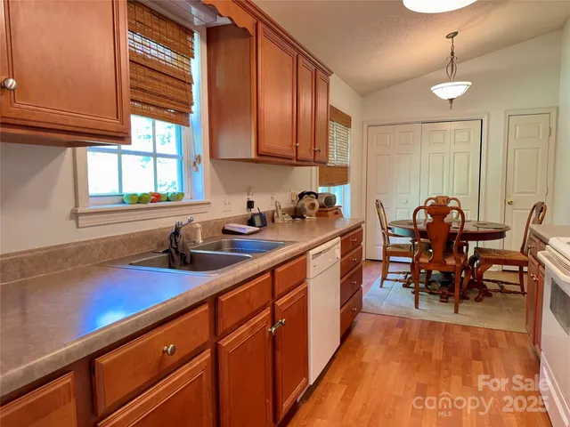 a kitchen with granite countertop sink cabinets and window