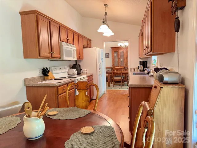 a open kitchen with stainless steel appliances granite countertop a refrigerator a sink a stove and island