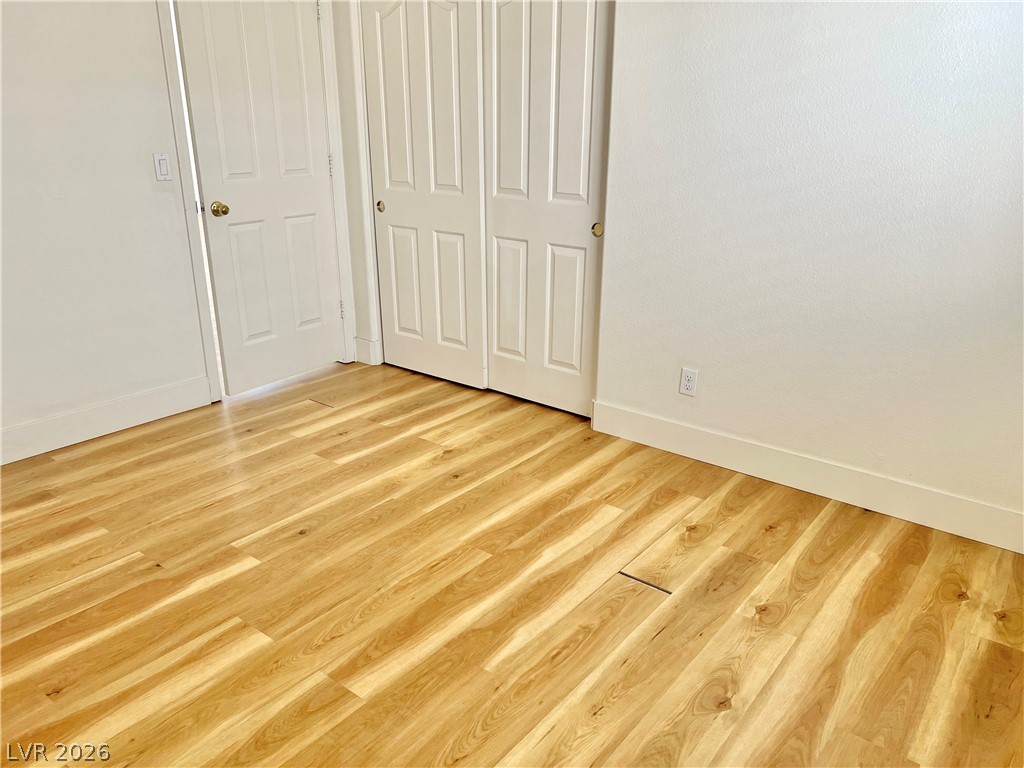 9708 Ridge Creek Place Las Vegas, NV 89134 - Photo 21 of 34 3rd Bedroom Luxury vinyl plank floors grace this well-lit room, complemented by crisp white trim and a closet ready for storage.