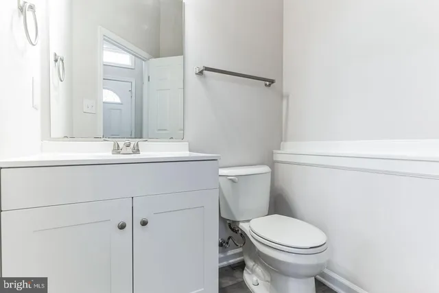 a bathroom with a sink toilet and mirror
