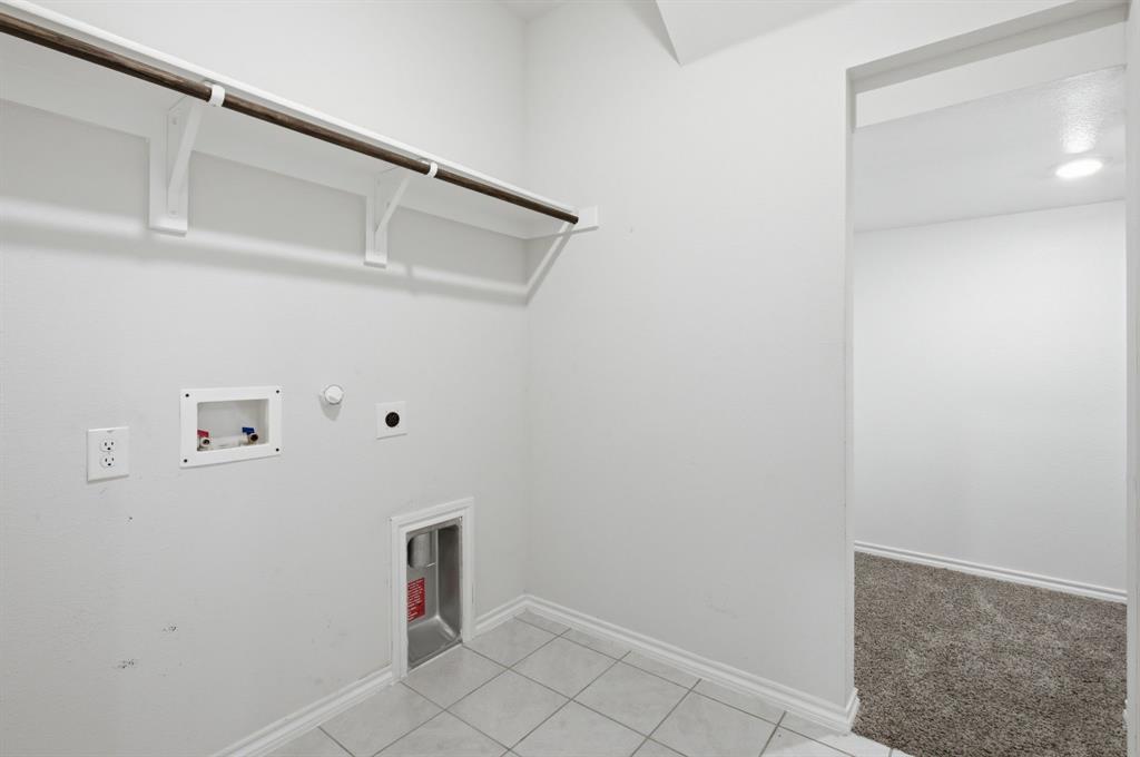 1328 Broaddus Road Forney, TX 75126 - Photo 23 of 31 Dedicated utility space with tile flooring, white baseboards, and bright white walls