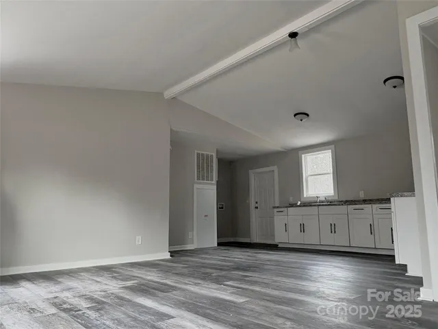a view of a livingroom with an empty space and a window