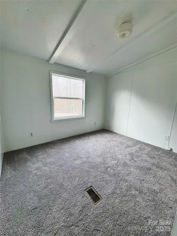 an empty room with a empty space and windows