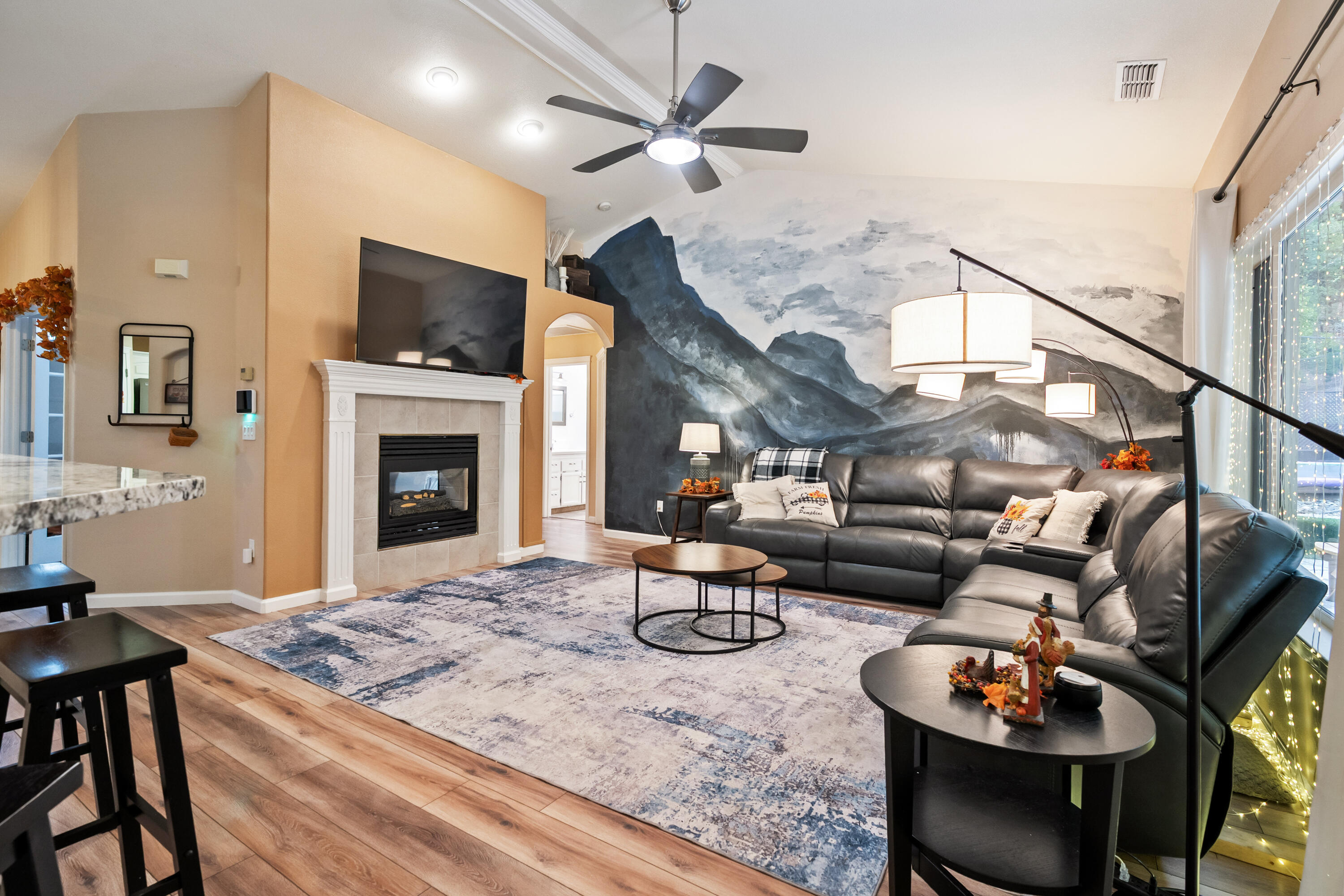 19219 Nike Court Redding, CA 96003 - Photo 12 of 37 a living room with furniture a fireplace and a flat screen tv