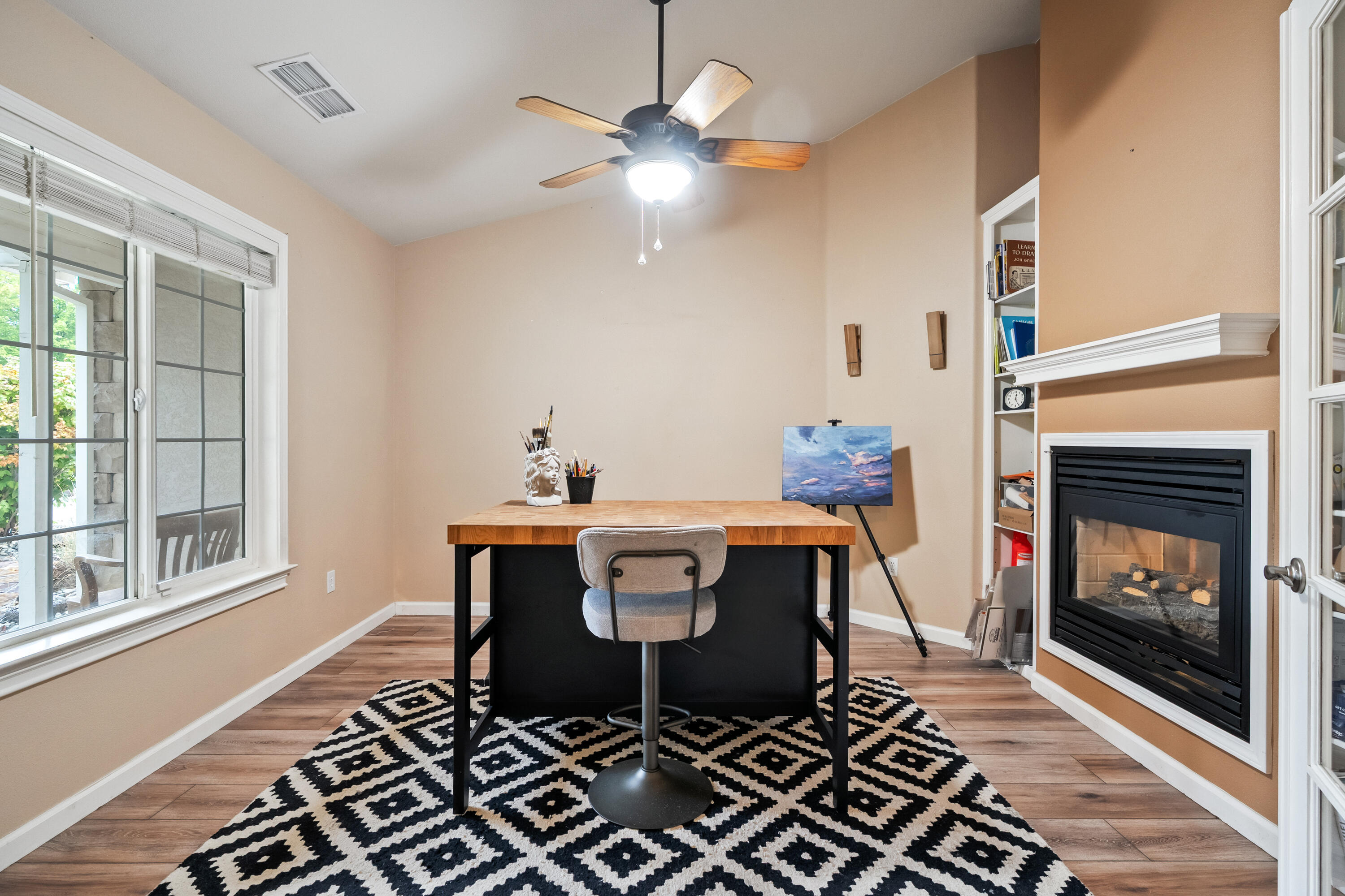 19219 Nike Court Redding, CA 96003 - Photo 14 of 37 a dining room with a fireplace a chandelier and wooden floor