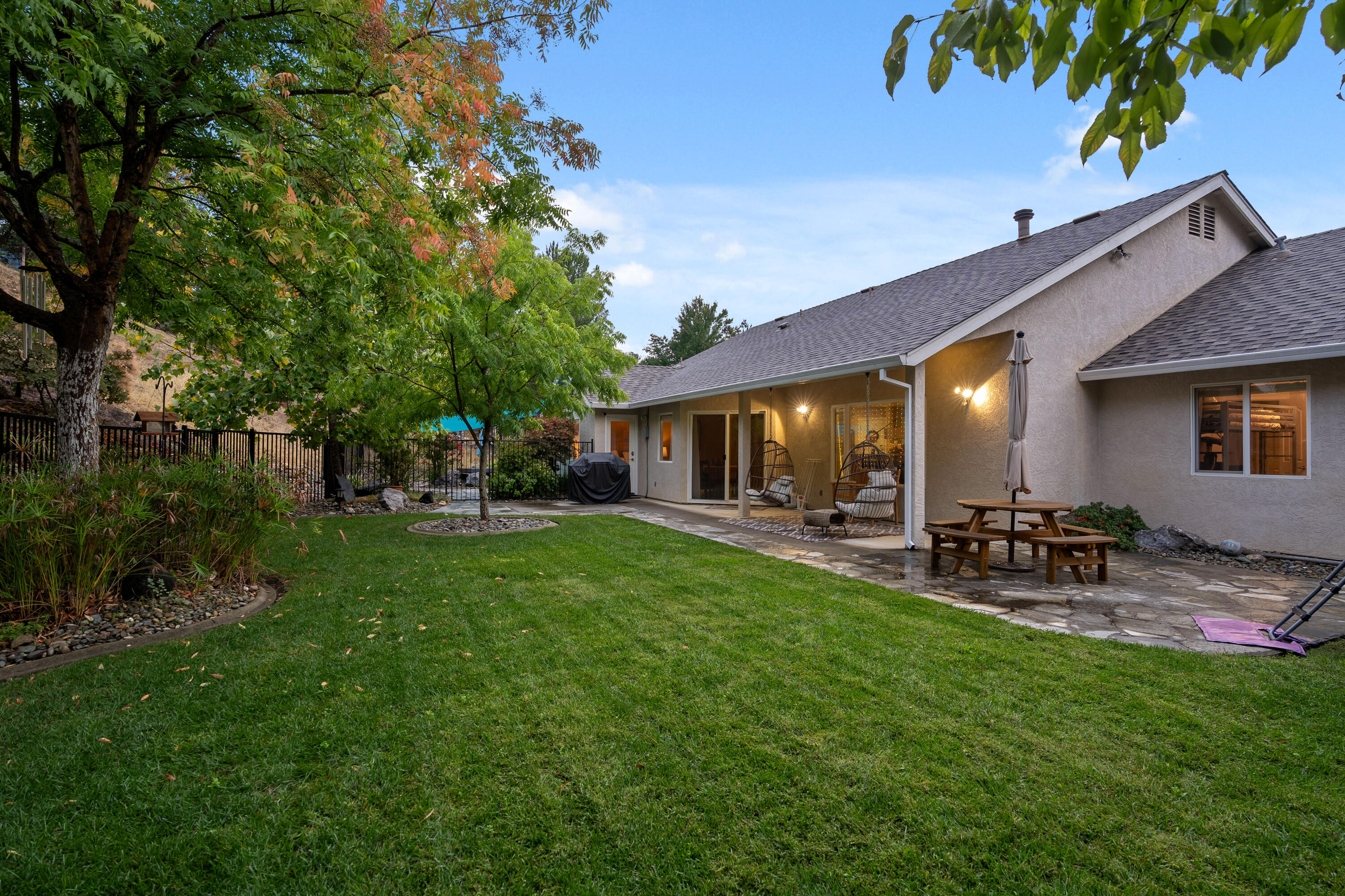 19219 Nike Court Redding, CA 96003 - Photo 26 of 37 a view of a patio with table and chairs under an umbrella