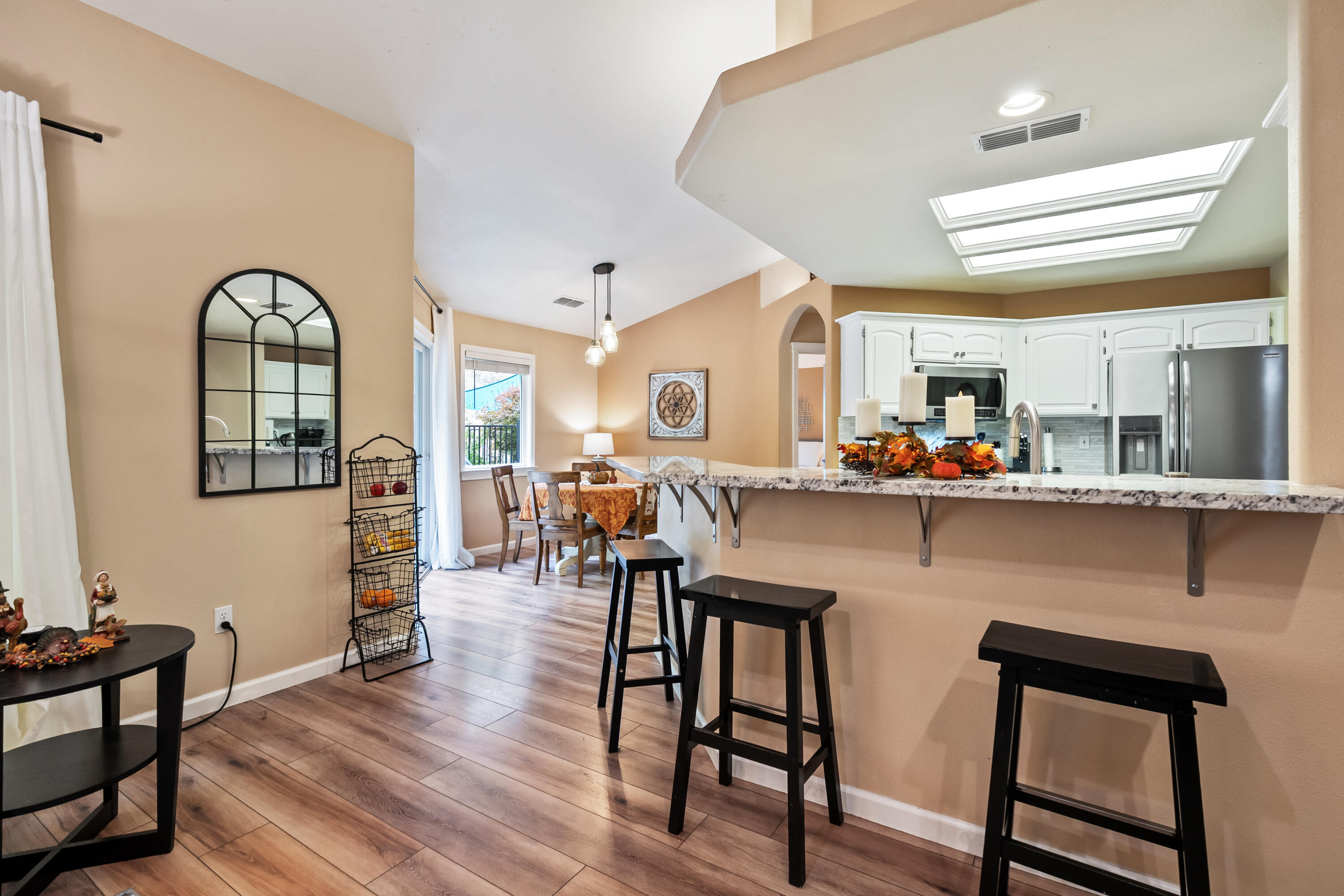 19219 Nike Court Redding, CA 96003 - Photo 10 of 37 a living room with stainless steel appliances kitchen island granite countertop furniture and a wooden floor