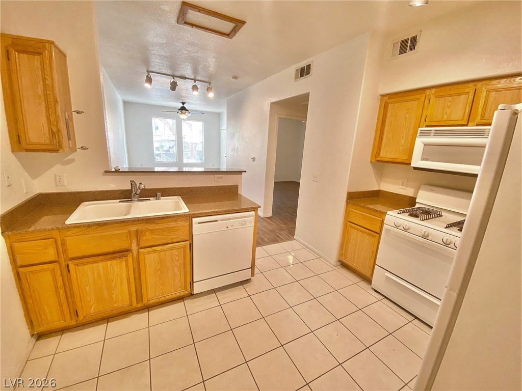 10550 West Alexander Road, Unit 1131 Las Vegas, NV 89129 - Photo 6 of 18 A well-maintained kitchen with ample cabinetry and a practical layout.