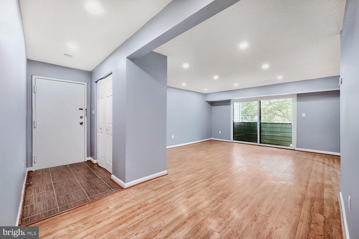 3 Windblown Court, Unit 102 Baltimore, MD 21209 - Photo 5 of 11 a view of an empty room with wooden floor and a window