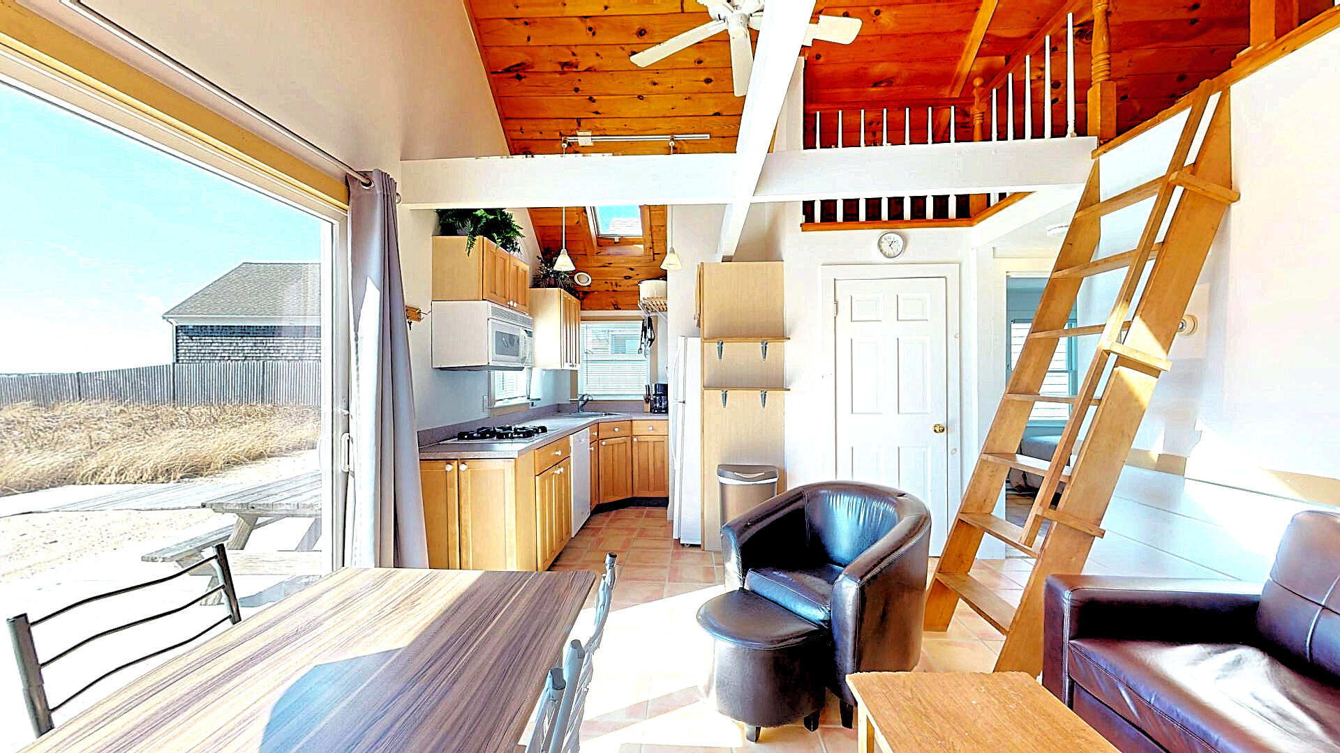 596 Shore Road, Unit G Truro, MA 02666 - Photo 5 of 27 a view of a kitchen with furniture and a window