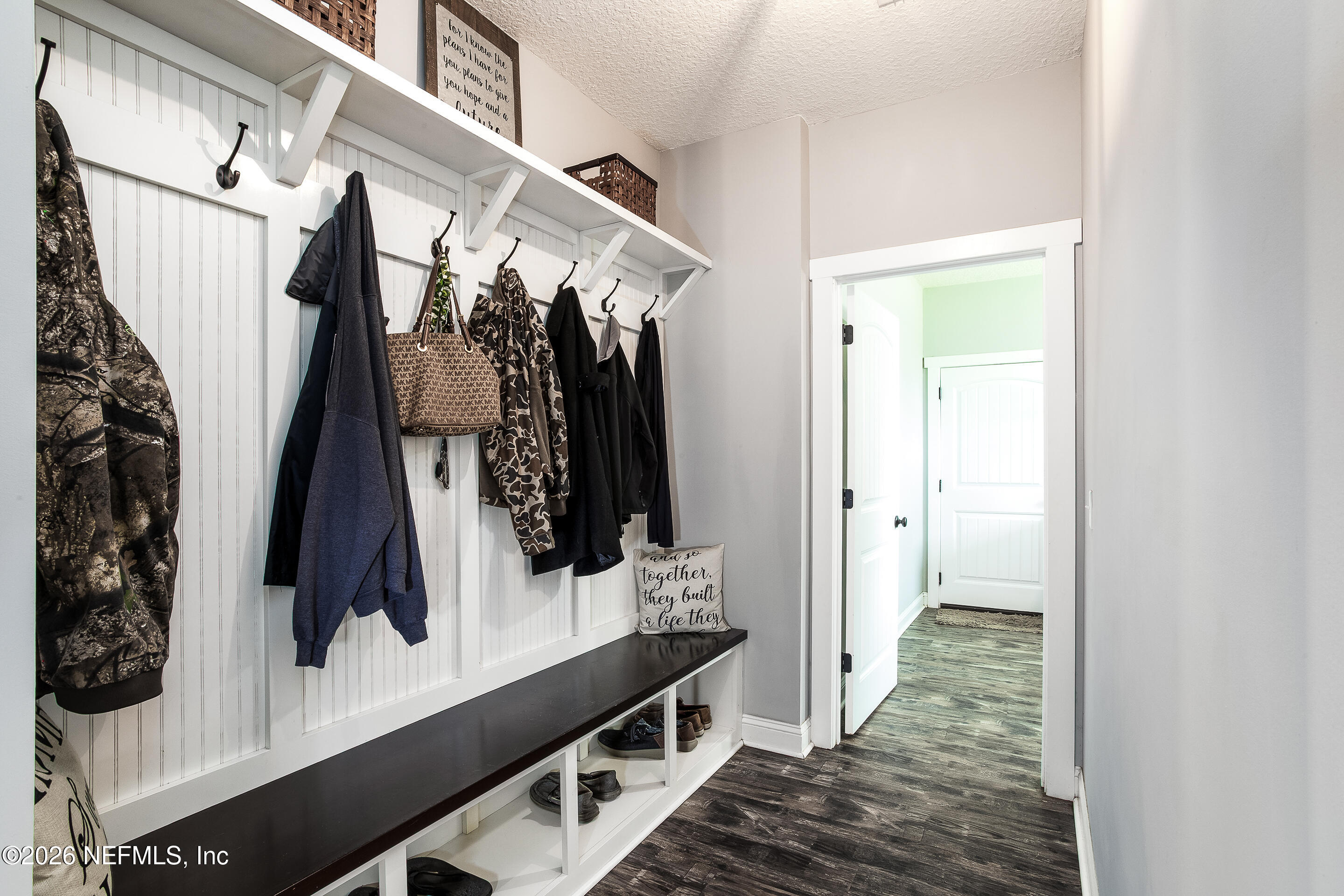 26575 Sheared Stokes Road Hilliard, FL 32046 - Photo 18 of 39 a view of walk in closet with clothes and shoes