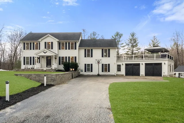 a front view of a house with a garden and yard