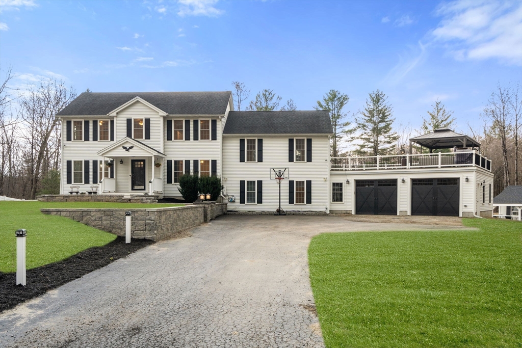 2 Britlees Way Dudley, MA 01571 - Photo 1 of 40 a front view of a house with a garden and yard