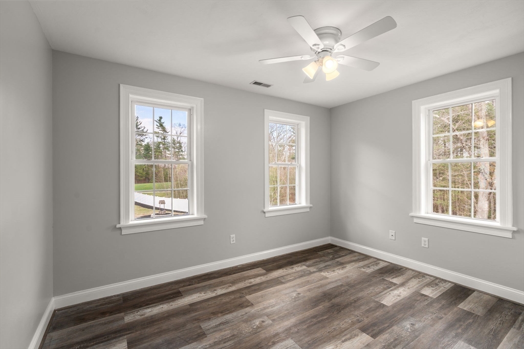 2 Britlees Way Dudley, MA 01571 - Photo 22 of 40 a view of an empty room with a window and a ceiling fan