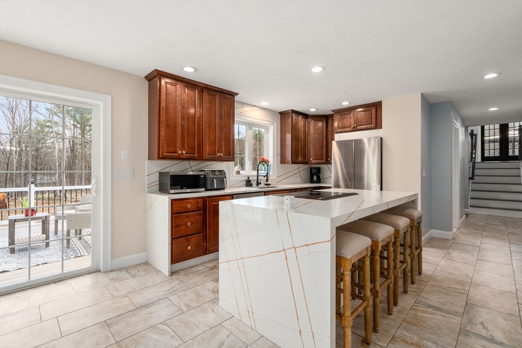 2 Britlees Way Dudley, MA 01571 - Photo 6 of 40 a kitchen with stainless steel appliances granite countertop a refrigerator and a stove top oven