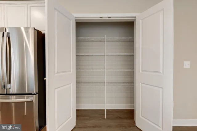 a view of walk in closet with empty racks