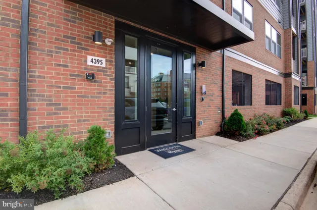 a view of a hallway with wooden floor and closet