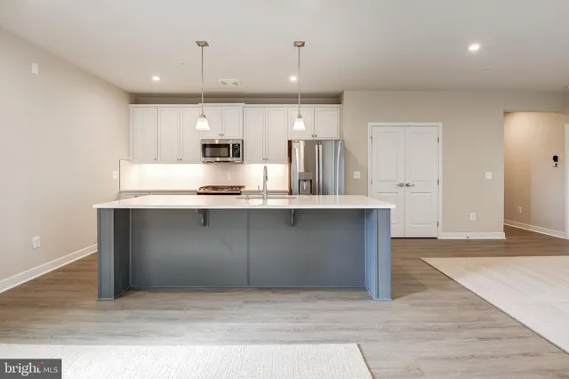 a kitchen with kitchen island cabinets and refrigerator
