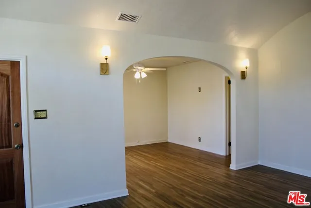 a view of a room with wooden floor